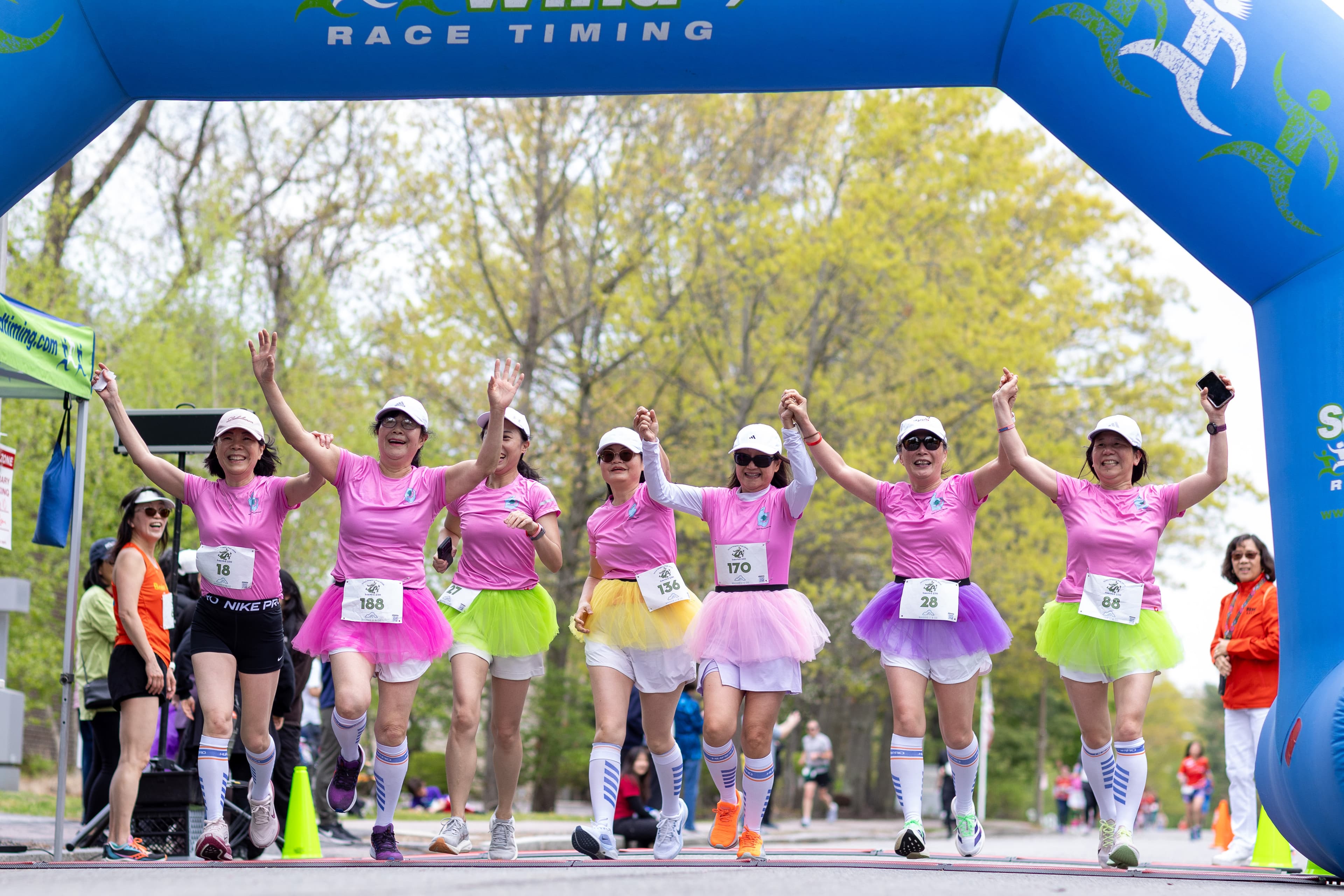 Boston Snail Running Club members celebrating at a race finish line